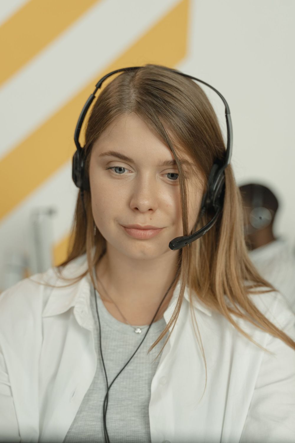 An agent with a headset at her desk