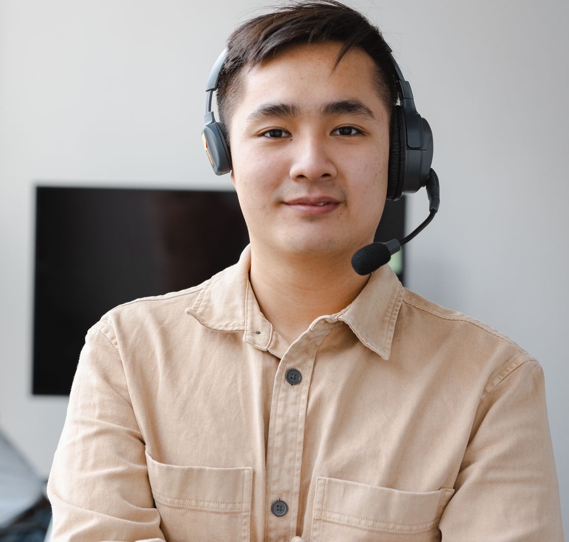 An agent with a headset smiling at the camera