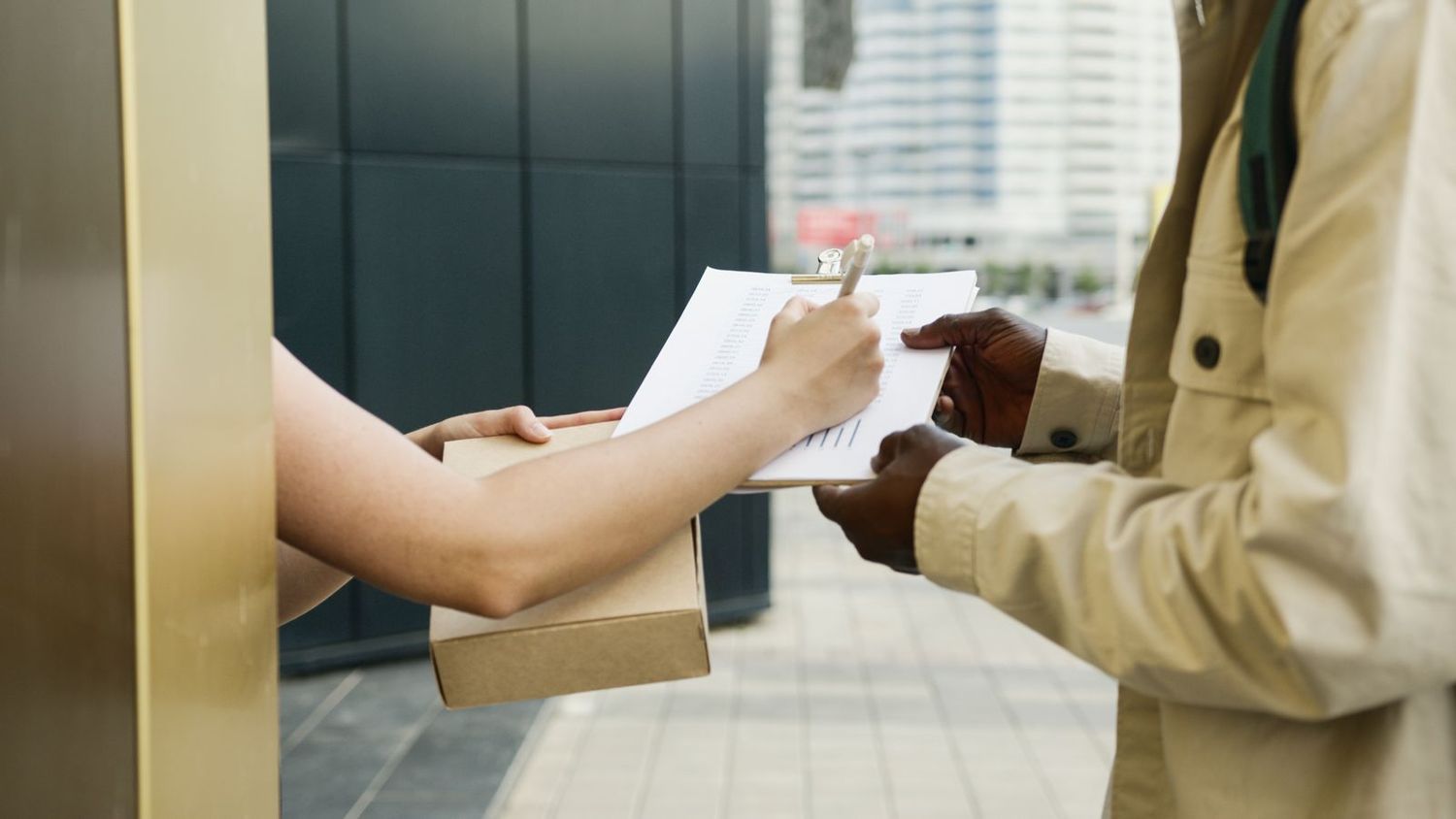 A customer signing for a parcel delivery