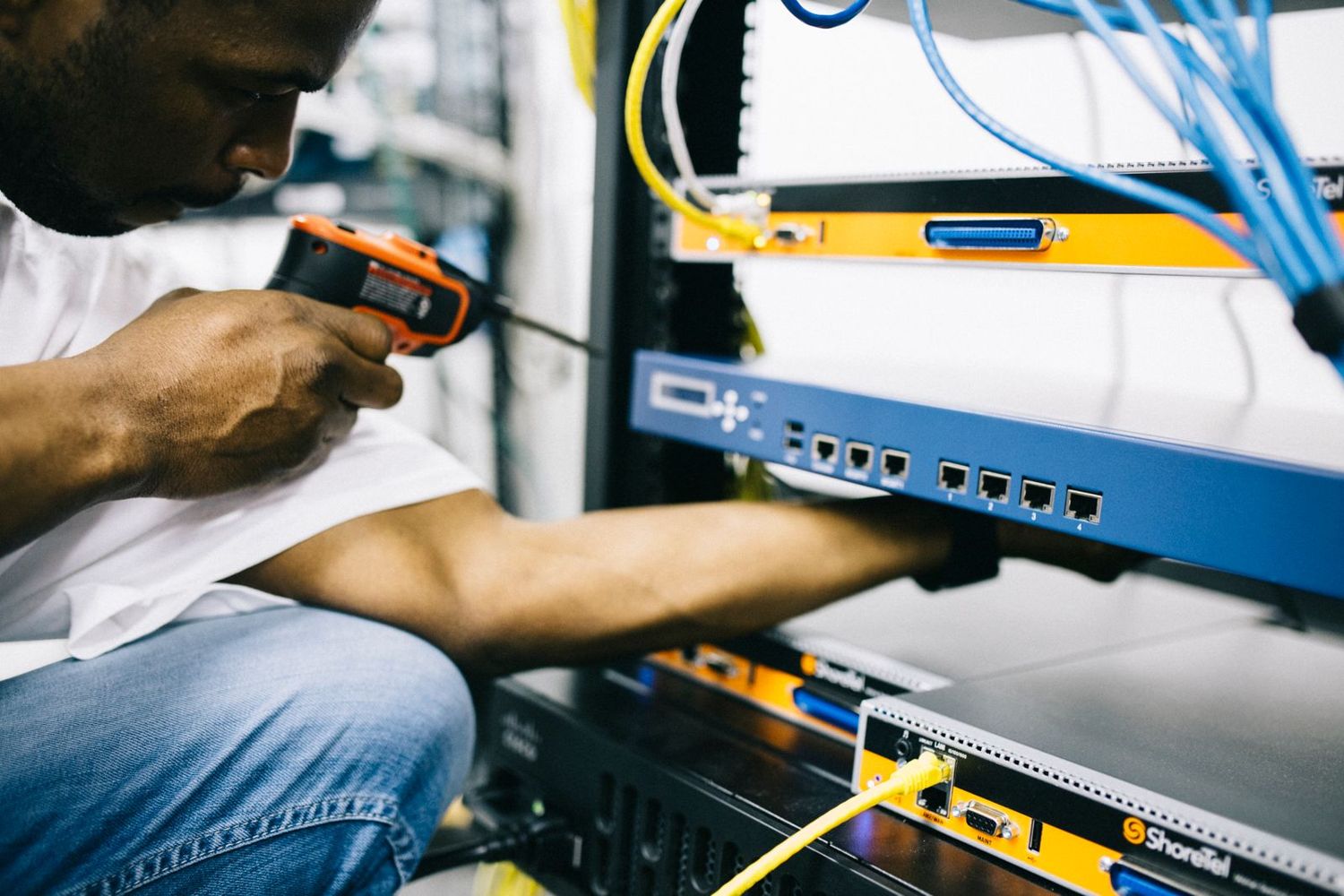 A technician working on network equipment
