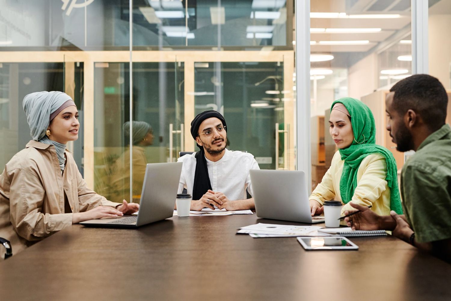 A bid team working together around a meeting table